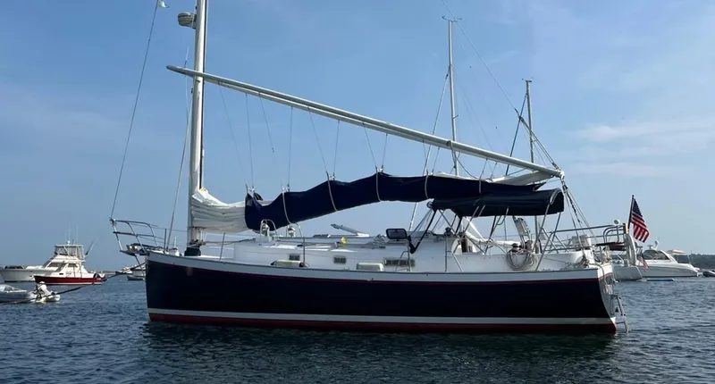 Slide: The Image of Sailboat Nonsuch 33, 2005 model, anchored in calm waters with clear blue sky. - 37