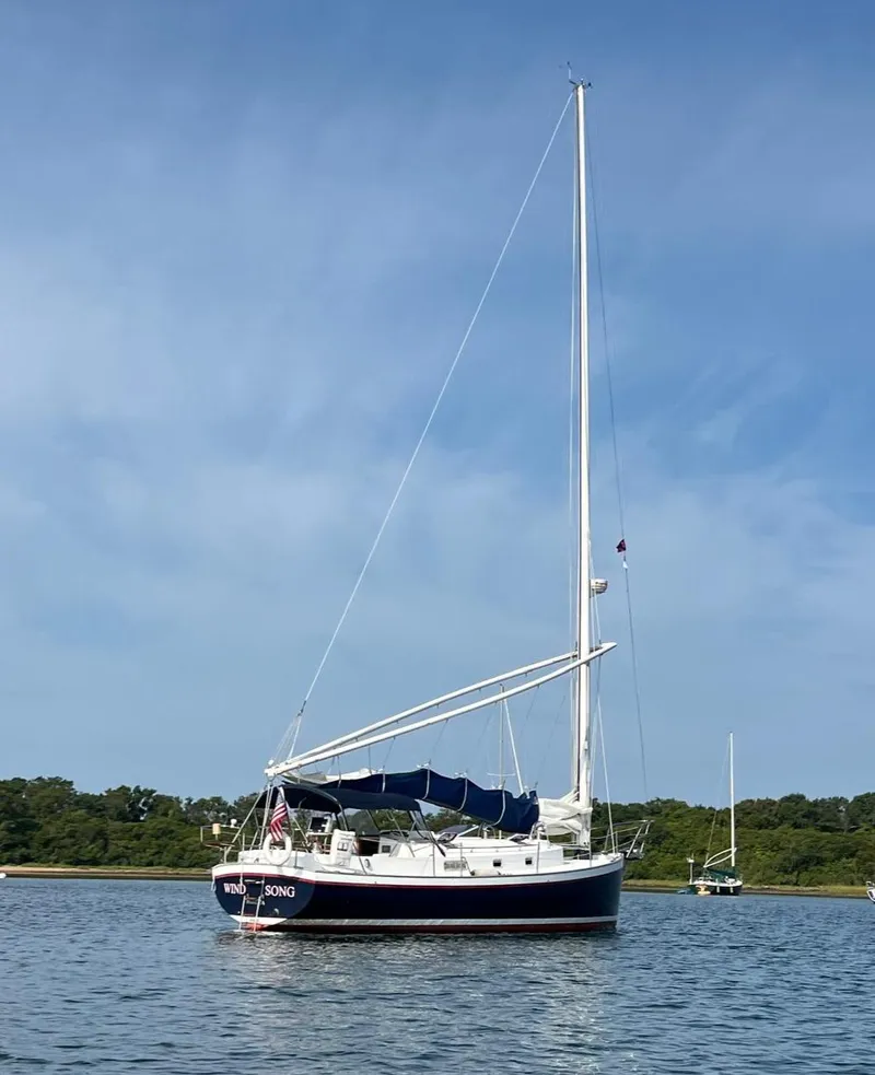 Slide: The Image of Sailboat on calm water, Nonsuch 33 model, 2005, with clear blue sky background. - 38