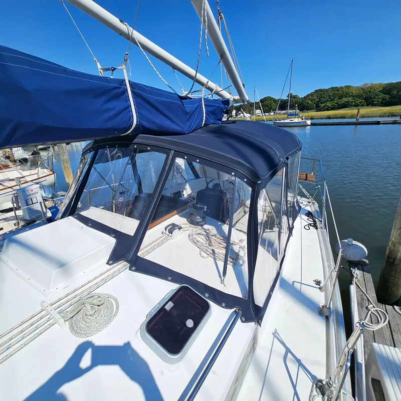 Slide: The Image of Sailboat Nonsuch 33, 2005 model, docked with blue canopy and clear windows. - 4
