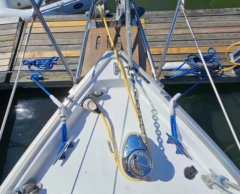 Slide: The Image of Bow of 2005 Nonsuch 33 sailboat docked, featuring anchor chain and ropes. - 5