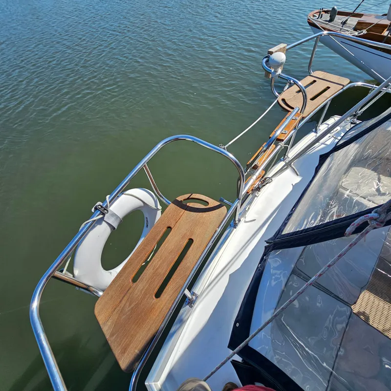 Slide: The Image of Nonsuch 33 sailboat deck with wooden seats and life preserver, 2005 model. - 6