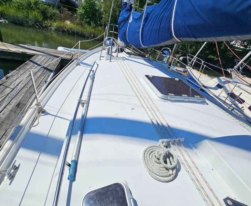 Slide: The Image of Nonsuch 33 sailboat deck with blue sail cover, docked, 2005 model. - 8