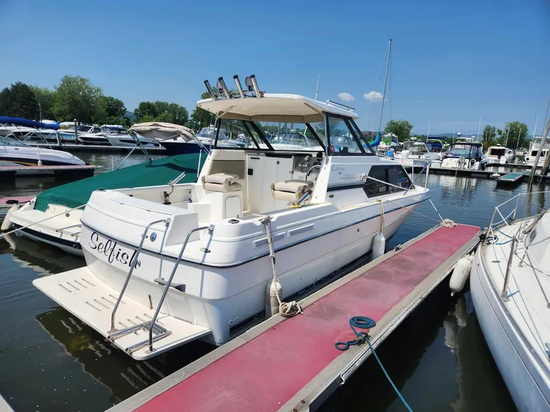 Slide: The Image of 1999 Bayliner 2452 Ciera Express docked at marina, sunny day, clear sky. - 3