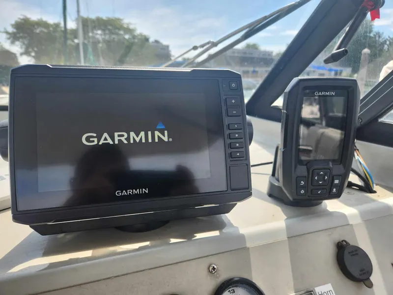 Slide: The Image of Garmin navigation devices on 1999 Bayliner 2452 Ciera Express boat dashboard. - 5