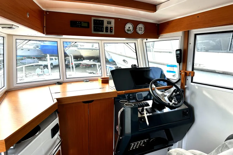 Slide: The Image of Interior of 2023 Sargo 28 boat with modern helm and wooden cabinetry. - 15