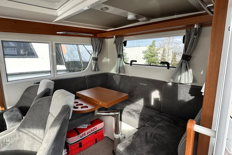 Slide: The Image of Interior of 2023 Sargo 28 boat with seating area and table. - 17