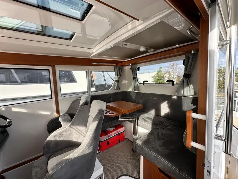 Slide: The Image of Interior of 2023 Sargo 28 boat with plush seating and wooden accents. - 18