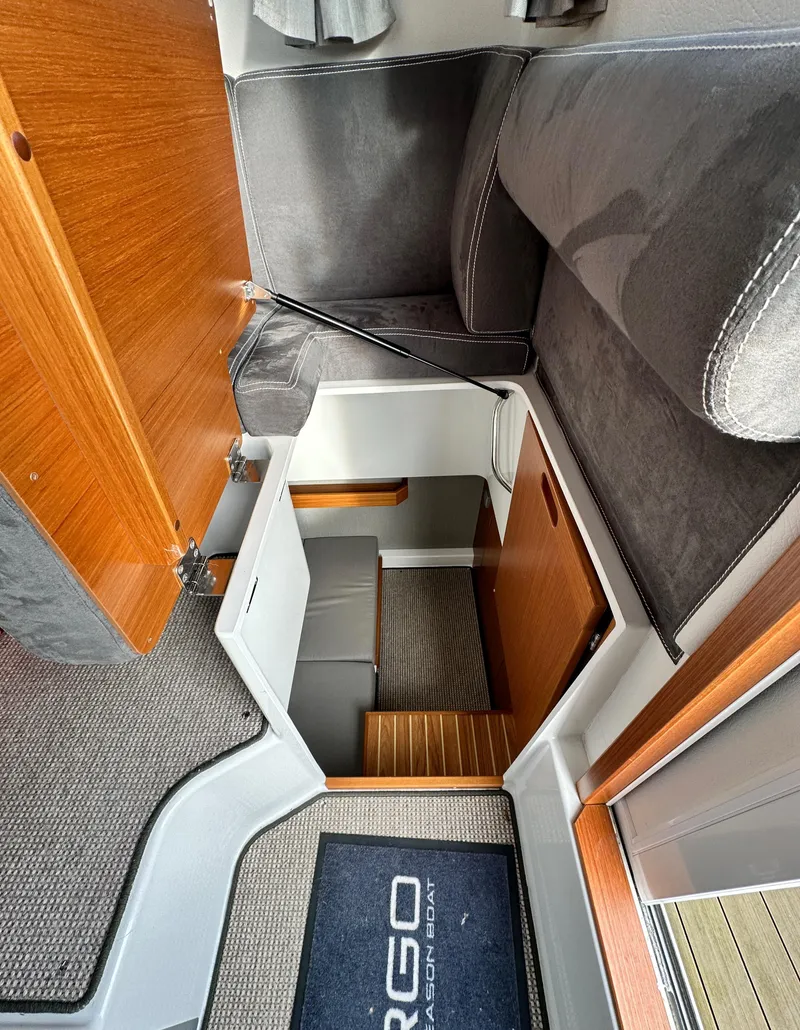 Slide: The Image of Interior of 2023 Sargo 28 boat, featuring wooden stairs and modern seating. - 20