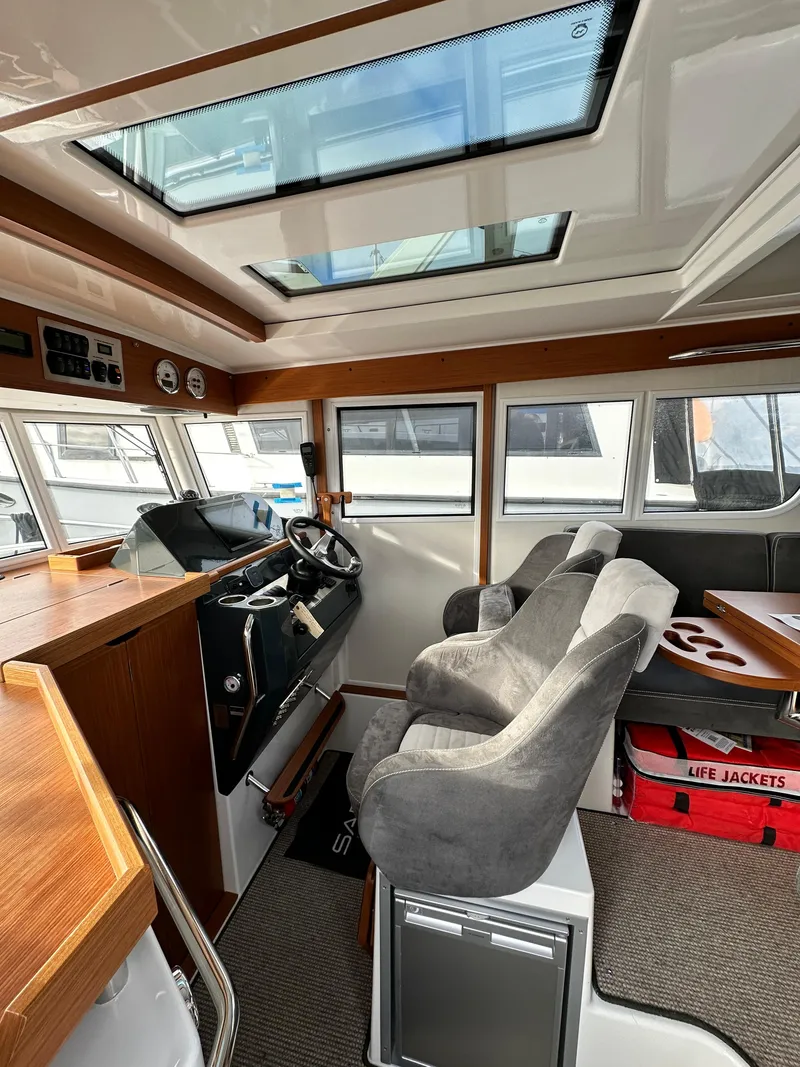 Slide: The Image of Interior of 2023 Sargo 28 boat with modern helm, seating, and safety equipment. - 24