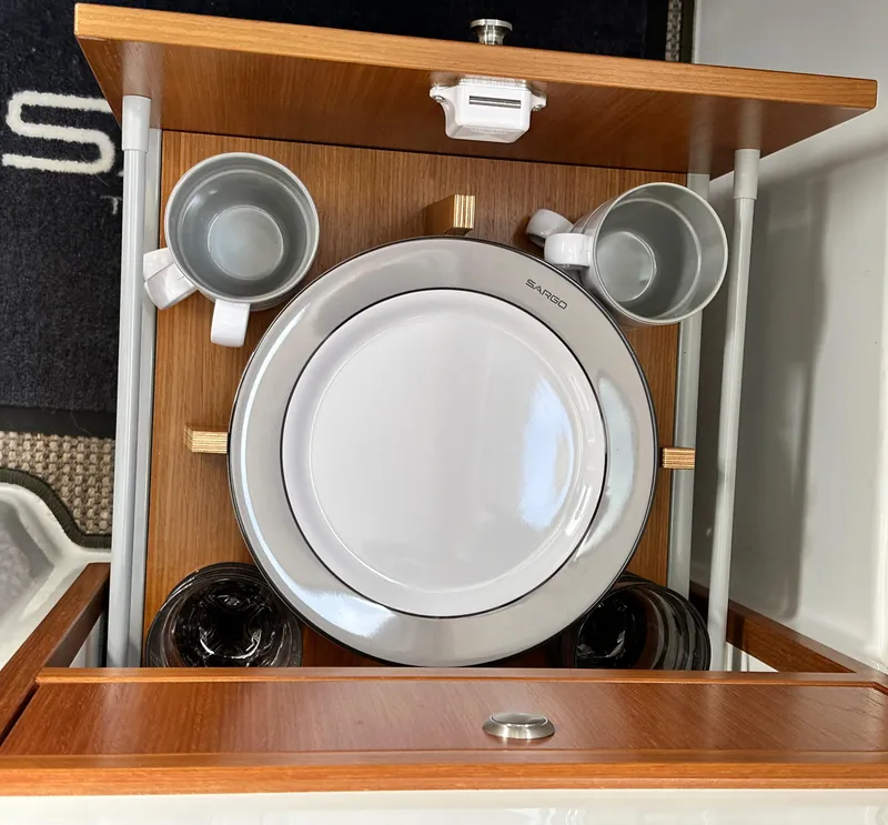 Slide: The Image of Sargo 28 boat interior with neatly arranged dishes and cups, 2023 model. - 25