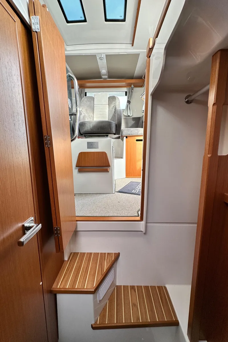 Slide: The Image of Interior view of 2023 Sargo 28 boat with wooden steps and modern design. - 26