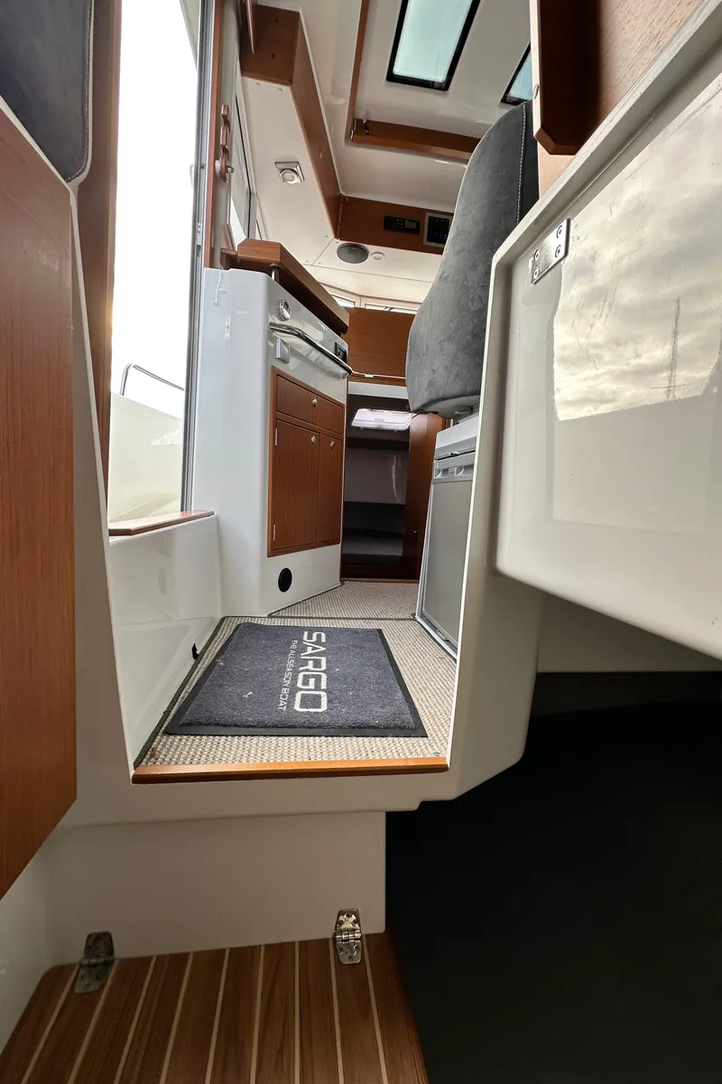 Slide: The Image of Interior view of 2023 Sargo 28 boat, featuring modern design and wood accents. - 27