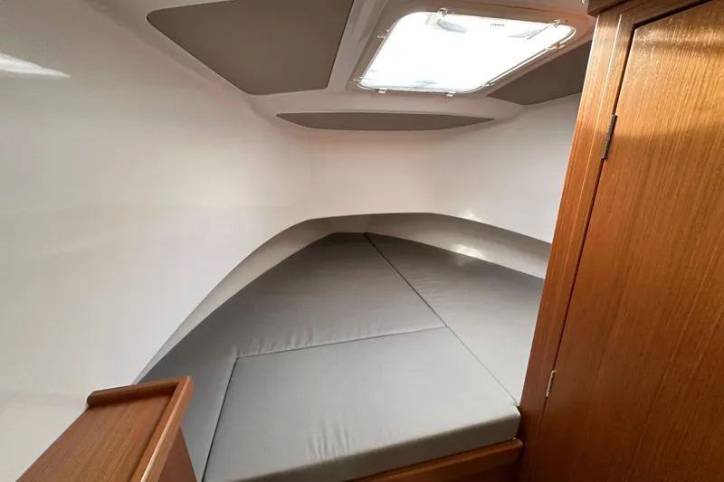 Slide: The Image of 2023 Sargo 28 cabin interior with gray cushions and wooden accents. - 35