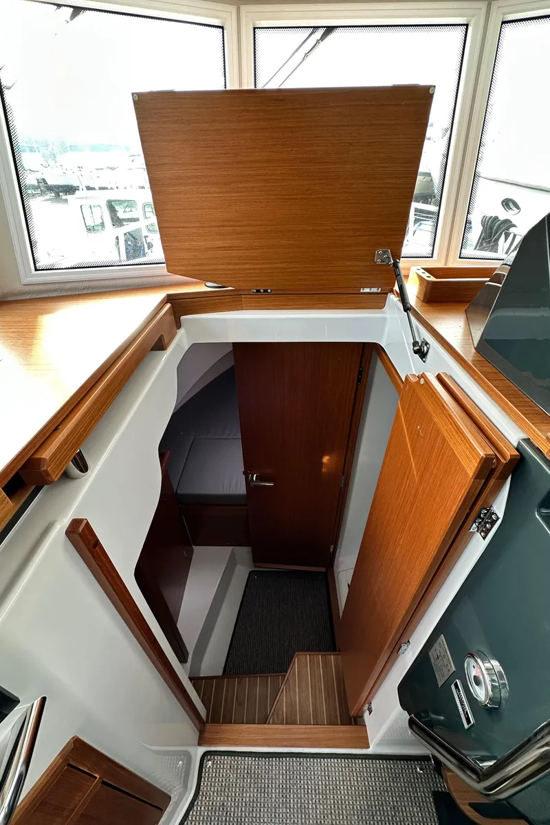 Slide: The Image of Interior view of 2023 Sargo 28 boat cabin with wooden finishes. - 37