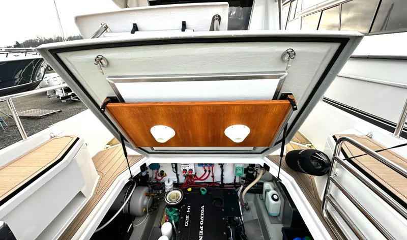 Slide: The Image of 2023 Sargo 28 boat engine compartment with open hatch, showcasing Volvo Penta engine. - 9