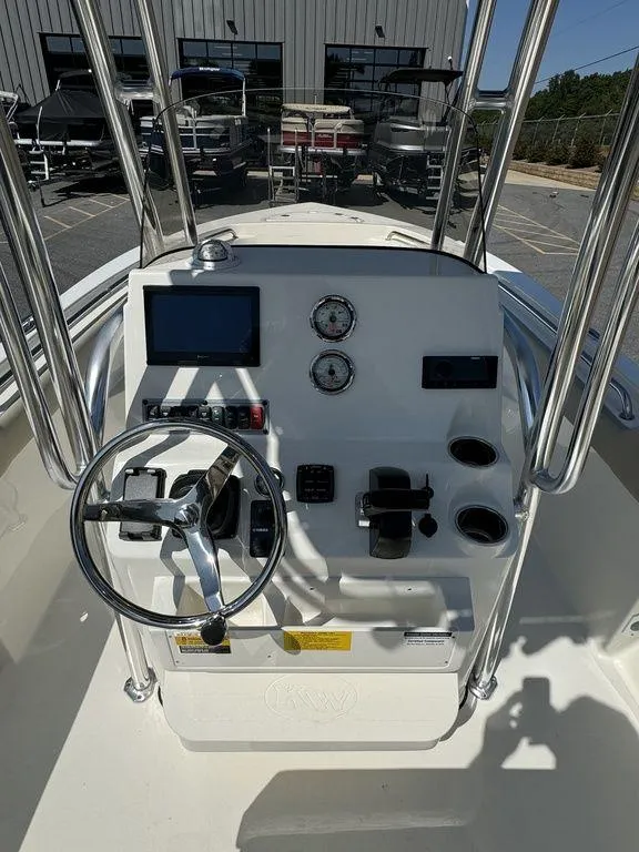 Slide: The Image of 2025 Key West 203 FS boat interior, featuring spacious seating and storage compartments. - 10
