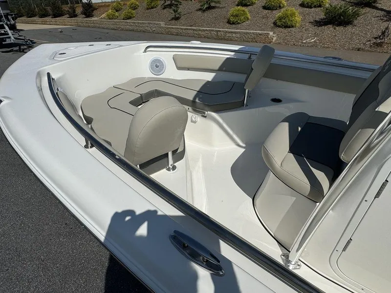 Slide: The Image of 2025 Key West 203 FS boat interior with cushioned seating and cup holders. - 12