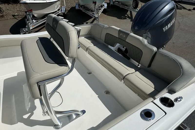 Slide: The Image of 2025 Key West 203 FS boat interior with Yamaha engine, featuring cushioned seating and stainless steel fixtures. - 16