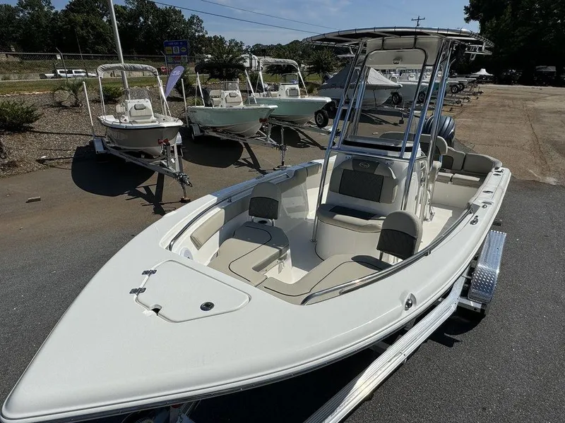 Slide: The Image of 2025 Key West 203 FS boat with Yamaha 150 engine at dealership parking lot. - 9