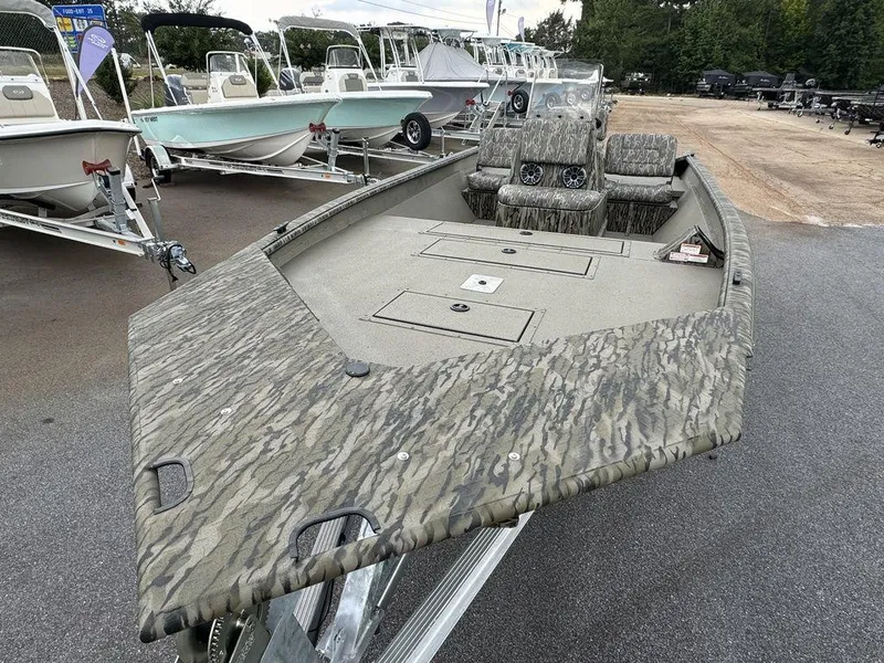 Slide: The Image of 2025 SeaArk Shadow 20 Elite CC boat with camouflage design on a trailer. - 10