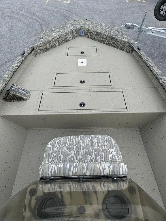 Slide: The Image of 2025 SeaArk Shadow 20 Elite CC boat interior with camo seating and storage compartments. - 14