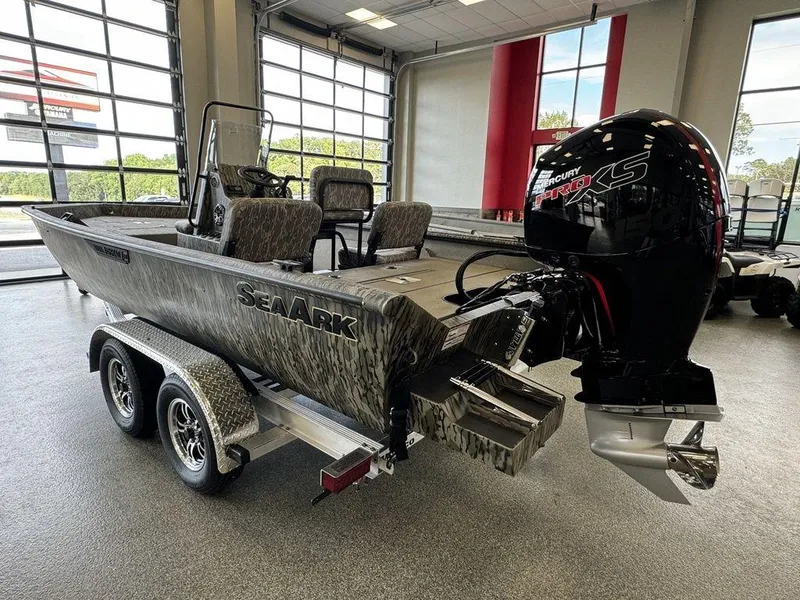 Slide: The Image of 2025 SeaArk Shadow 20 Elite CC boat with powerful outboard motor in showroom. - 3