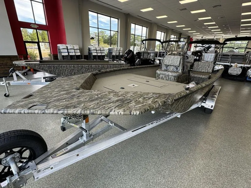Slide: The Image of 2025 SeaArk Shadow 20 Elite CC boat displayed in showroom, featuring camouflage design. - 4