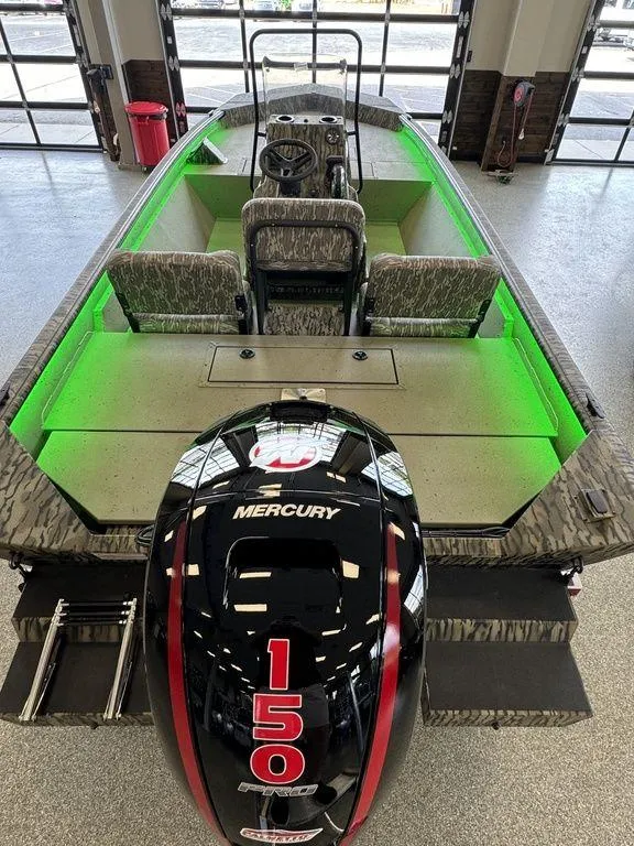 Slide: The Image of 2025 SeaArk Shadow 20 Elite CC boat with Mercury 150 engine and green interior lighting. - 5
