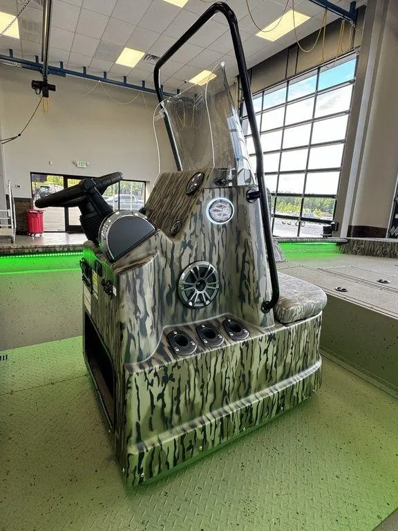 Slide: The Image of 2025 SeaArk Shadow 20 Elite CC boat console with camouflage design in a showroom. - 7