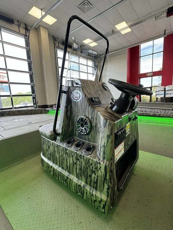 Slide: The Image of 2025 SeaArk Shadow 20 Elite CC boat console with camouflage design in showroom. - 8