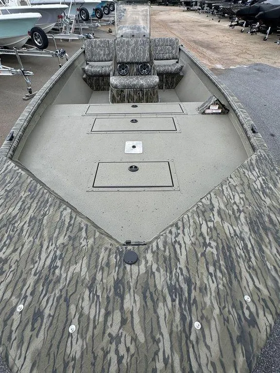 Slide: The Image of 2025 SeaArk Shadow 20 Elite CC boat with camouflage design, spacious deck, and seating. - 9