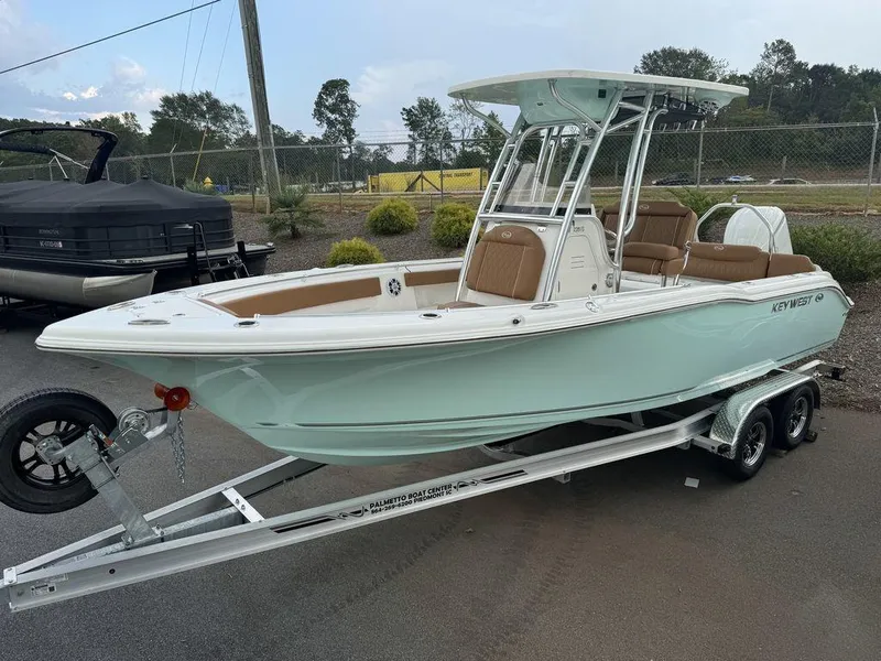 The Image of 2025 Key West 239FS boat on trailer, light blue hull, parked outdoors. - 1