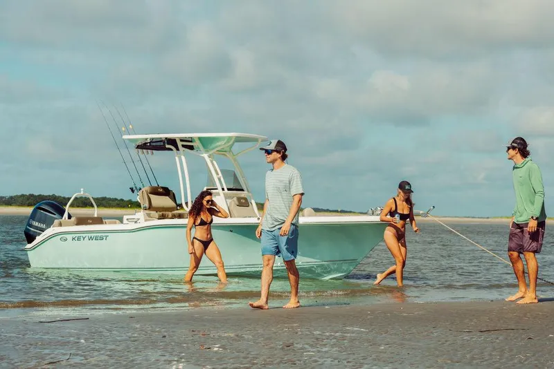 Slide: The Image of 2025 Key West 239FS boat with people enjoying a beach outing. - 4