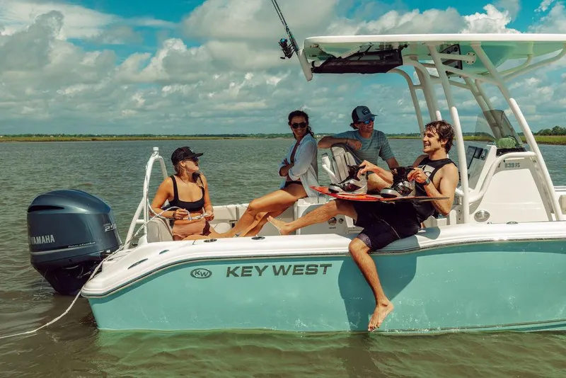 Slide: The Image of Group enjoying a day on a 2025 Key West 239FS boat in sunny waters. - 7