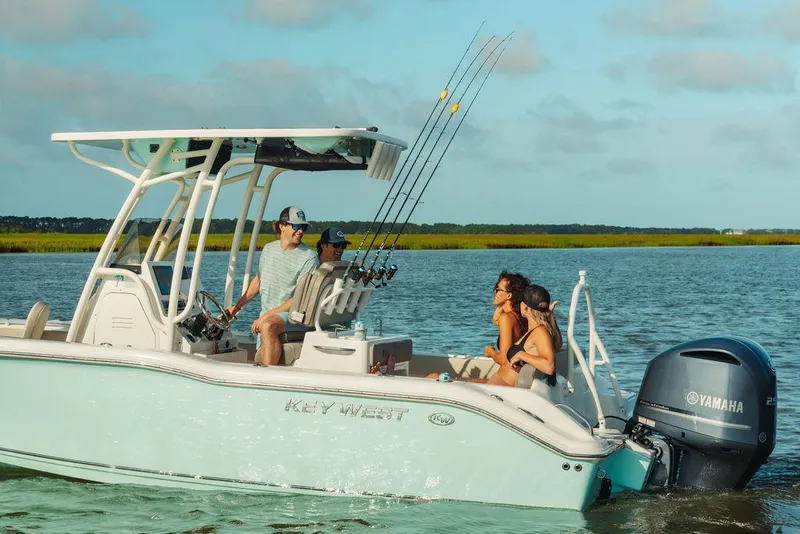 Slide: The Image of 2025 Key West 239FS boat with passengers enjoying a sunny day on the water. - 8