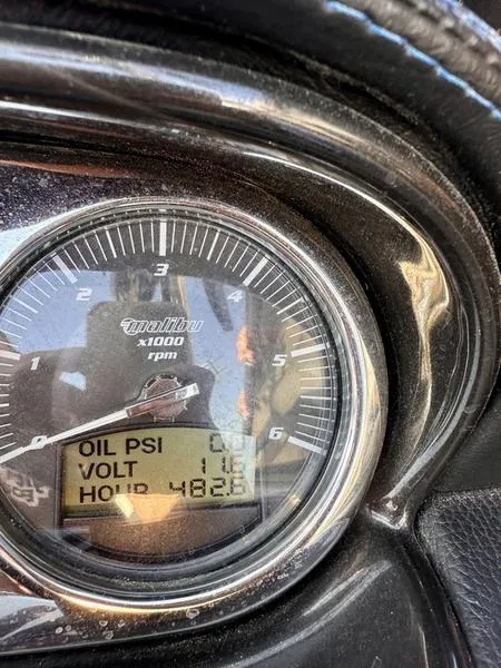 Slide: The Image of Close-up of 2013 Malibu Wakesetter 21 VLX dashboard gauge displaying oil PSI, voltage, and hours. - 12