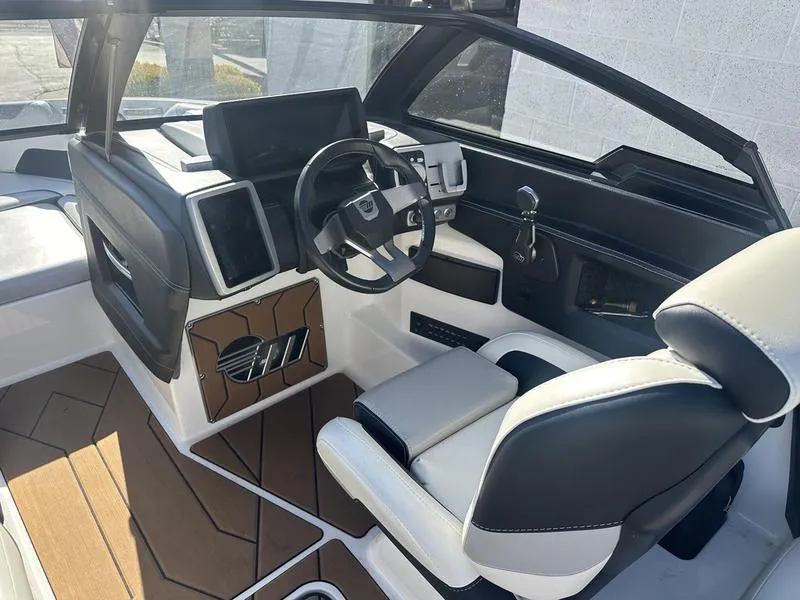 Slide: The Image of 2020 Malibu 23 LSV boat interior with modern dashboard and steering wheel. - 11