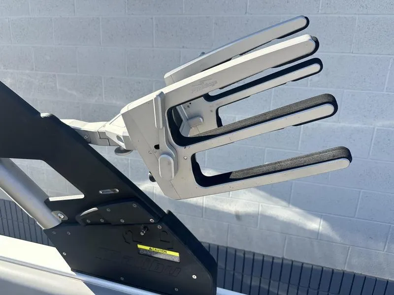 Slide: The Image of Wakeboard rack on a 2020 Malibu 23 LSV boat against a brick wall. - 12