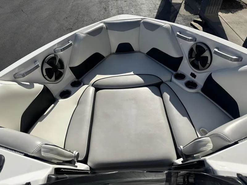 Slide: The Image of 2020 Malibu 23 LSV boat interior with cushioned seating and built-in speakers. - 13