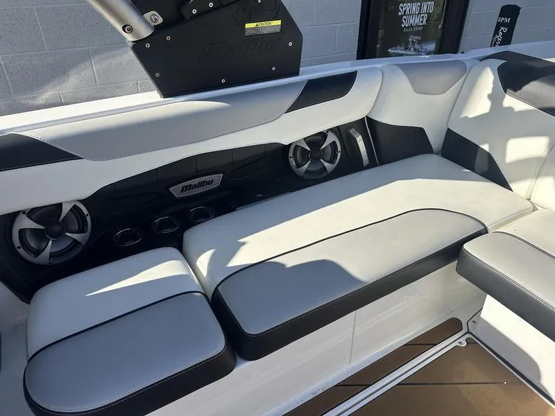 Slide: The Image of 2020 Malibu 23 LSV boat interior with white and black seating and speakers. - 9
