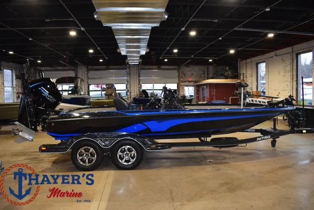 Slide: The Image of 2024 Nitro Z21 XL boat on trailer, parked outdoors. - 2