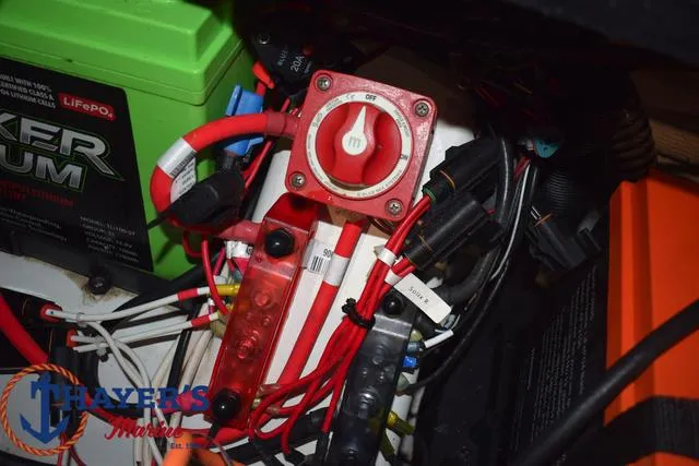 Slide: The Image of 2024 Nitro Z21 XL boat storage compartment with fire extinguisher and fishing gear. - 20