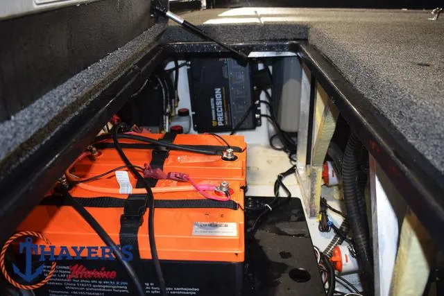 Slide: The Image of 2024 Nitro Z21 XL boat with trolling motor, parked near a Caperlan van. - 23