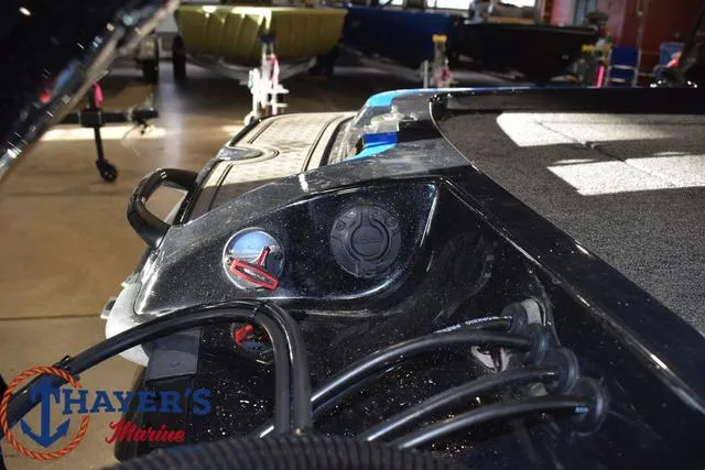 Slide: The Image of 2024 Nitro Z21 XL boat with powerful outboard motor in a parking lot. - 25