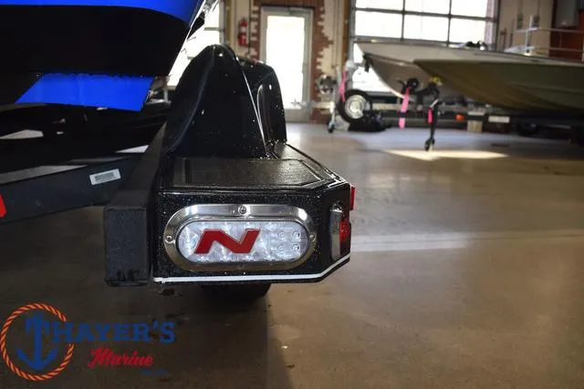 Slide: The Image of 2024 Nitro Z21 XL boat trailer with branded tail light in showroom. - 27