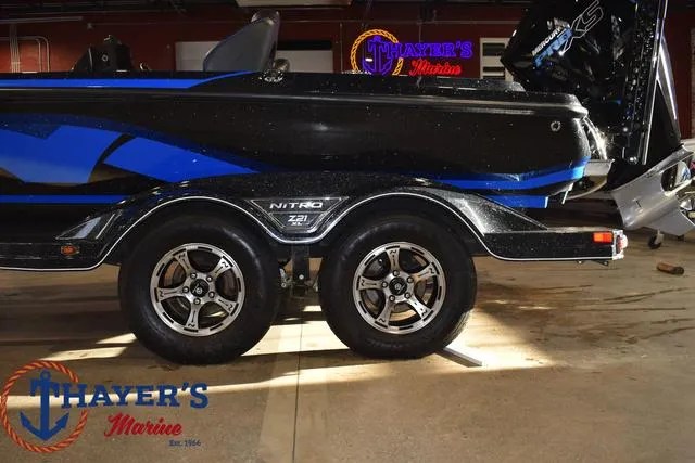 Slide: The Image of 2024 Nitro Z21 XL boat trailer with dual wheels at Thayer's Marine showroom. - 29