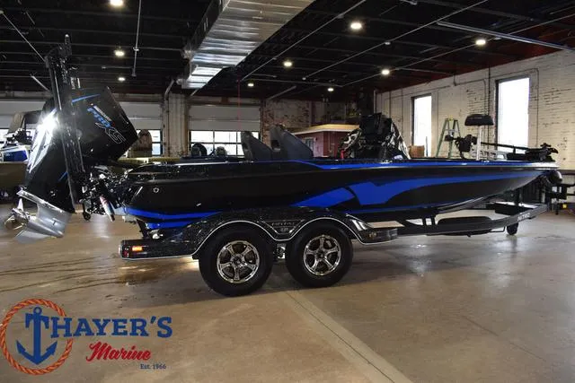 Slide: The Image of 2024 Nitro Z21 XL boat in showroom, featuring sleek black and blue design. - 37