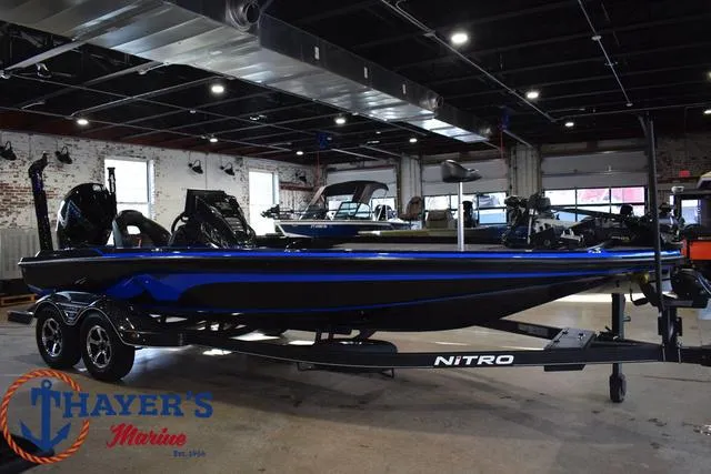 Slide: The Image of 2024 Nitro Z21 XL boat displayed indoors at Thayer's Marine showroom. - 39