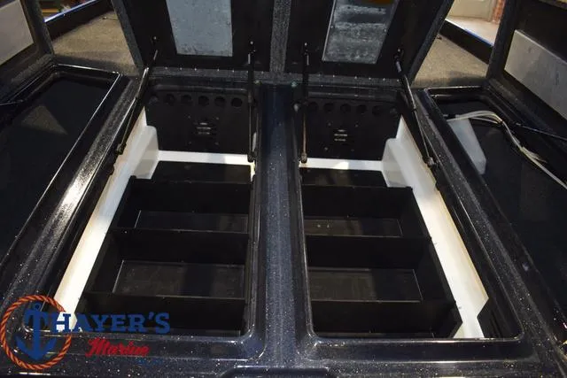 Slide: The Image of 2024 Nitro Z21 XL boat storage compartments with open lids, showcasing organized interior space. - 42