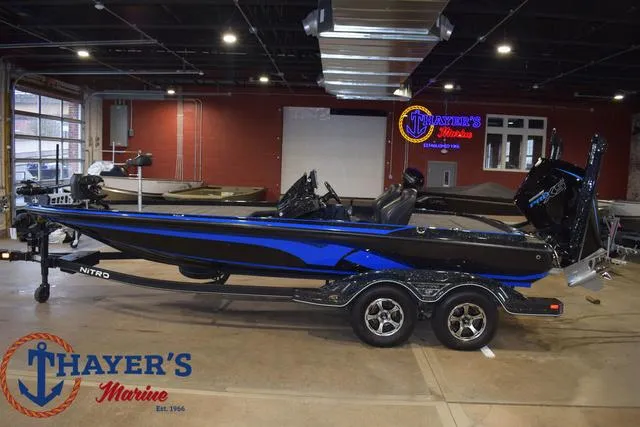 Slide: The Image of 2024 Nitro Z21 XL boat propeller and motor detail on pavement. - 7